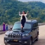 Scorpio Stunt : युवती ने चलती स्कॉर्पियो पर किया खतरनाक स्टंट, वाहन मालिक पर चालान